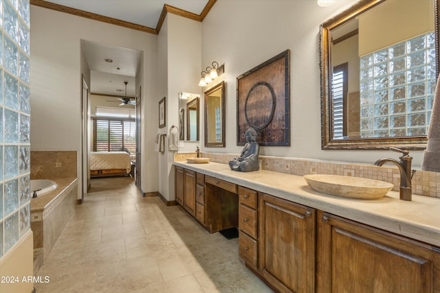 bathroom with vanity, crown molding, tile patterned flooring, ceiling fan, and tiled bath