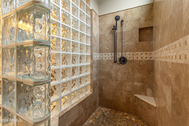 bathroom with tiled shower