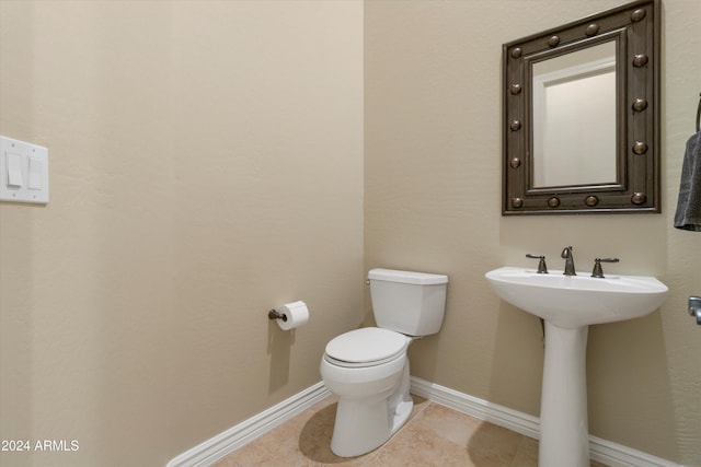 bathroom with sink, tile patterned flooring, and toilet