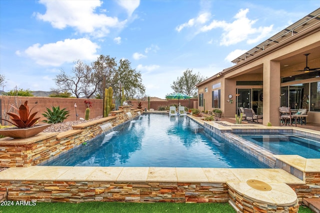 view of pool featuring an in ground hot tub, ceiling fan, pool water feature, and a patio