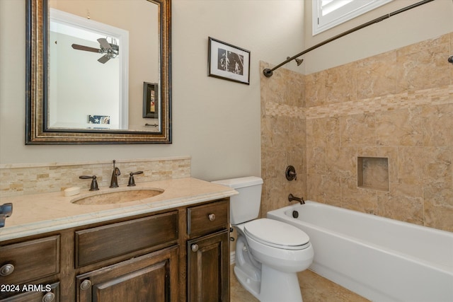 full bathroom with vanity, tiled shower / bath combo, toilet, and ceiling fan