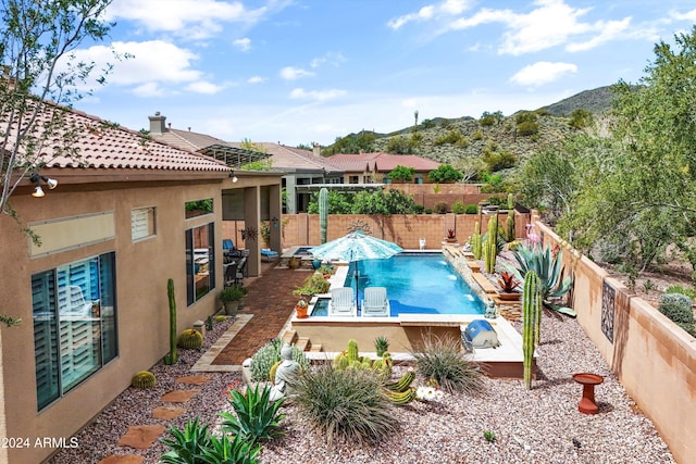 view of swimming pool with pool water feature