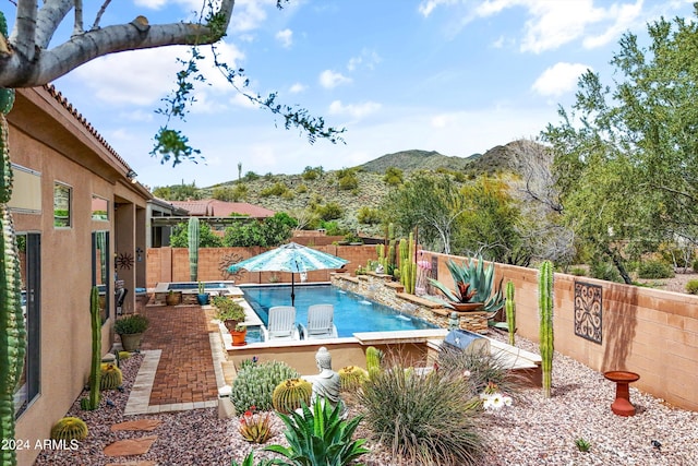 view of pool featuring a patio area, a mountain view, and pool water feature