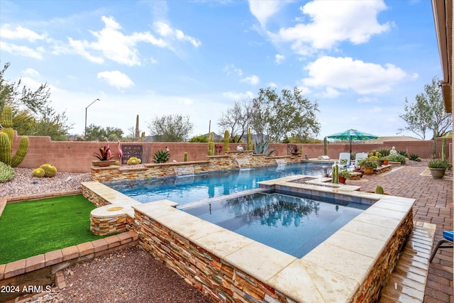 view of swimming pool featuring an in ground hot tub and pool water feature