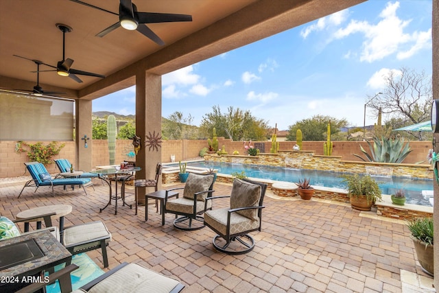 view of patio with pool water feature and ceiling fan