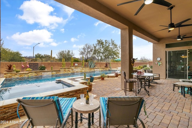 view of patio / terrace with a swimming pool with hot tub, pool water feature, and ceiling fan