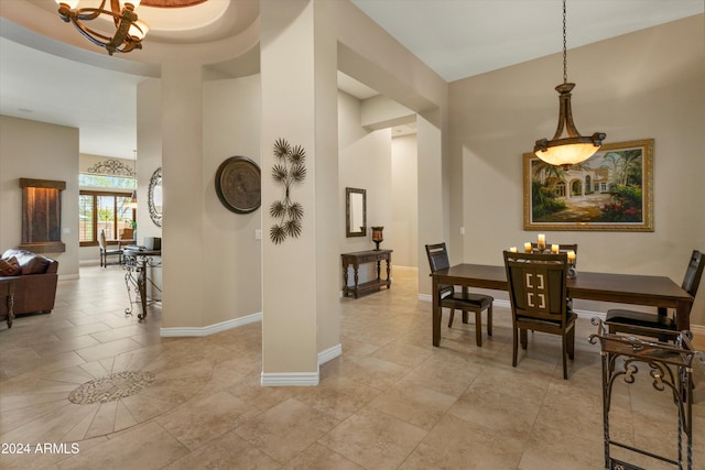 tiled dining area featuring a notable chandelier