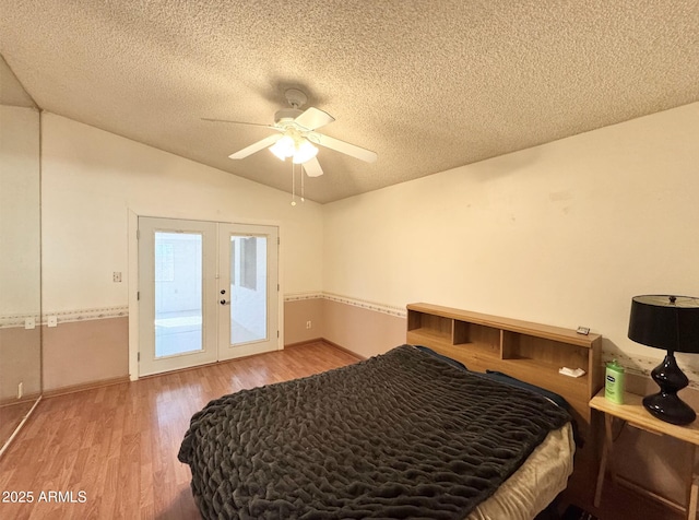 bedroom featuring access to exterior, vaulted ceiling, french doors, and wood-type flooring