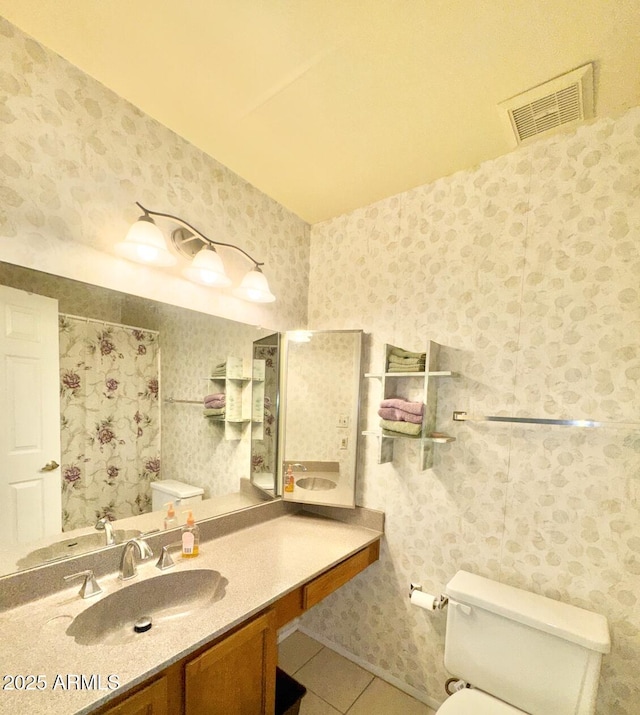 bathroom featuring tile patterned flooring, vanity, and toilet