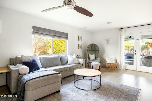 sitting room featuring ceiling fan, visible vents, wood finished floors, and french doors