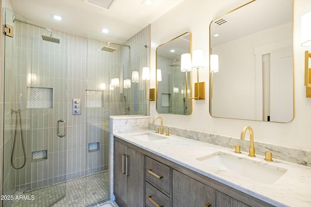 bathroom featuring a stall shower, a sink, recessed lighting, and double vanity