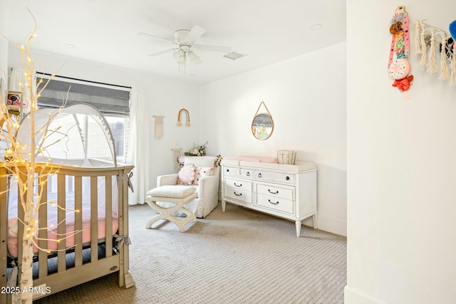 carpeted bedroom featuring visible vents and a ceiling fan