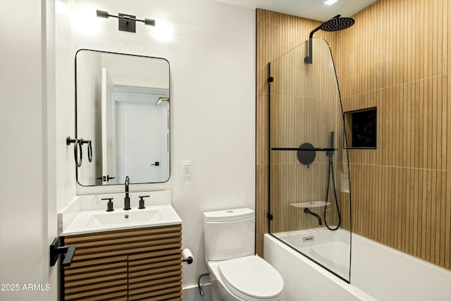 bathroom with toilet, bath / shower combo with glass door, and vanity