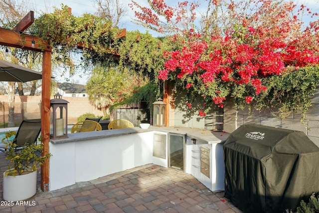 view of patio / terrace with a grill, area for grilling, and fence