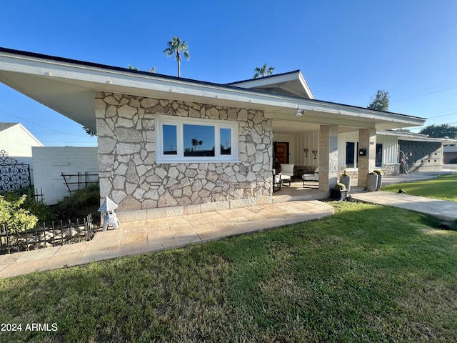 back of house with a lawn