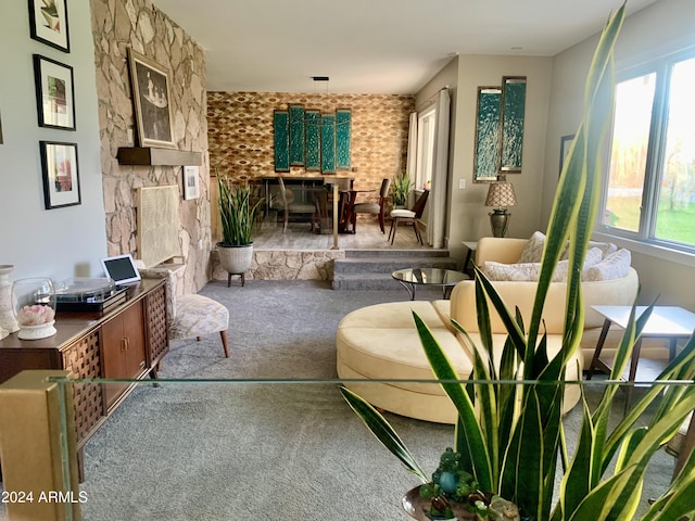 living area with a fireplace and carpet flooring