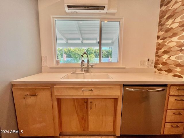 kitchen with sink, stainless steel dishwasher, and an AC wall unit