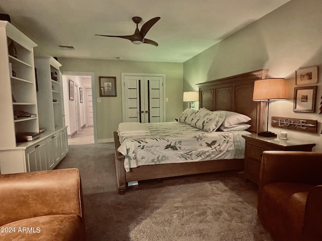 bedroom featuring ceiling fan and dark colored carpet