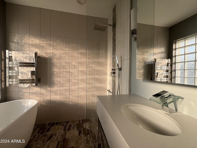 bathroom featuring shower with separate bathtub and sink