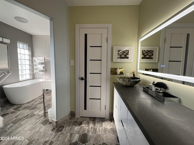 bathroom featuring a bathing tub and vanity