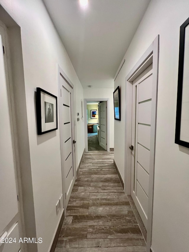 corridor featuring dark hardwood / wood-style floors