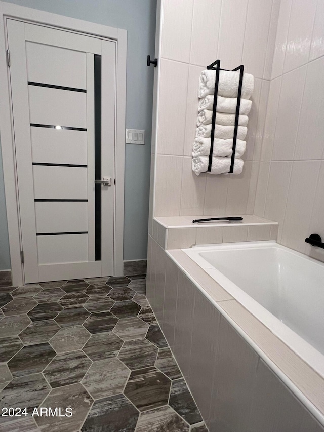 bathroom with a relaxing tiled tub