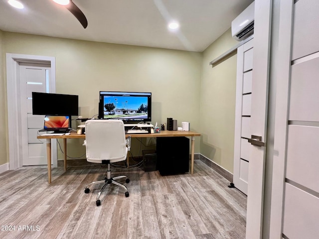 office featuring hardwood / wood-style flooring, an AC wall unit, and ceiling fan