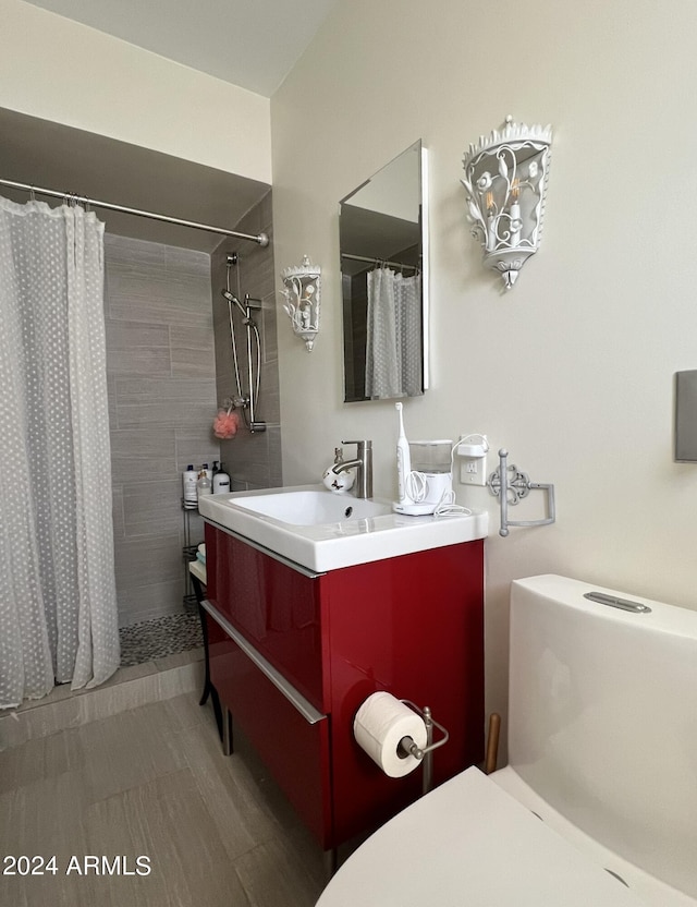 bathroom featuring vanity, curtained shower, and toilet