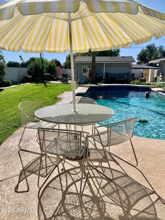 view of pool featuring a patio area and a lawn