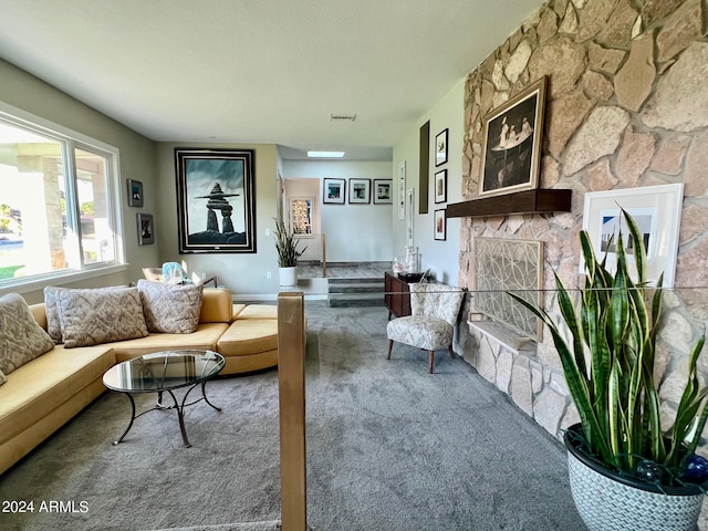 living room with carpet floors and a fireplace