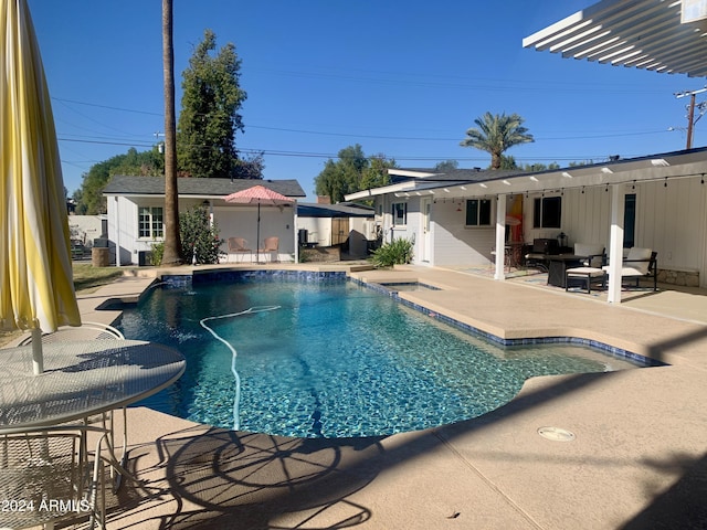 view of pool with a patio area and an outdoor structure