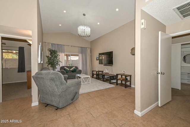 living room with an inviting chandelier, light tile patterned floors, and lofted ceiling