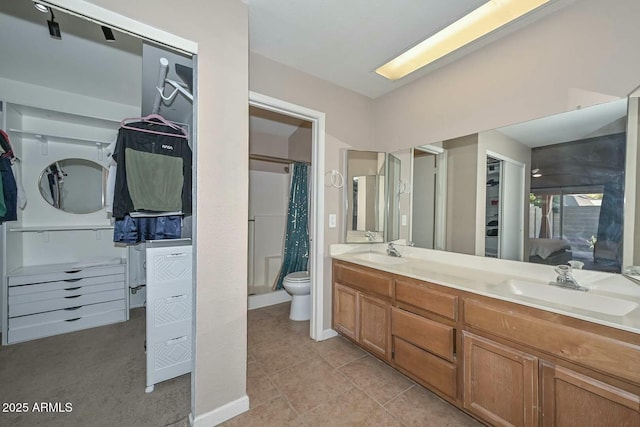 bathroom with walk in shower, toilet, tile patterned floors, and vanity