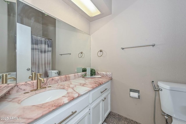 bathroom featuring toilet and vanity