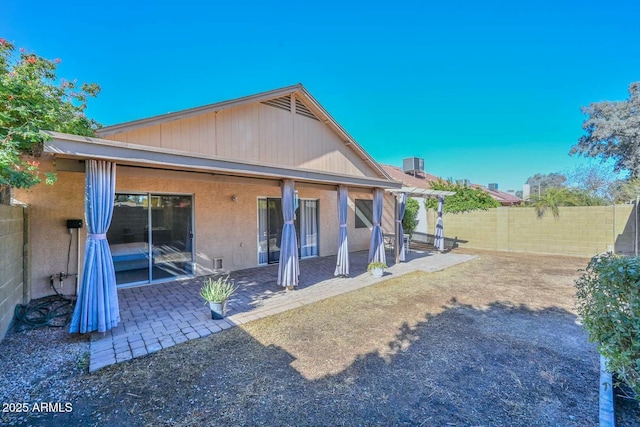 rear view of house with a patio and central AC unit