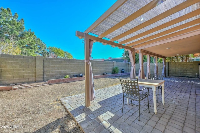 view of patio with a bar and a pergola