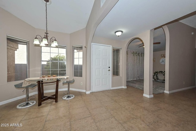 entrance foyer with ceiling fan with notable chandelier