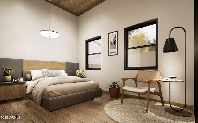 bedroom with vaulted ceiling and hardwood / wood-style floors