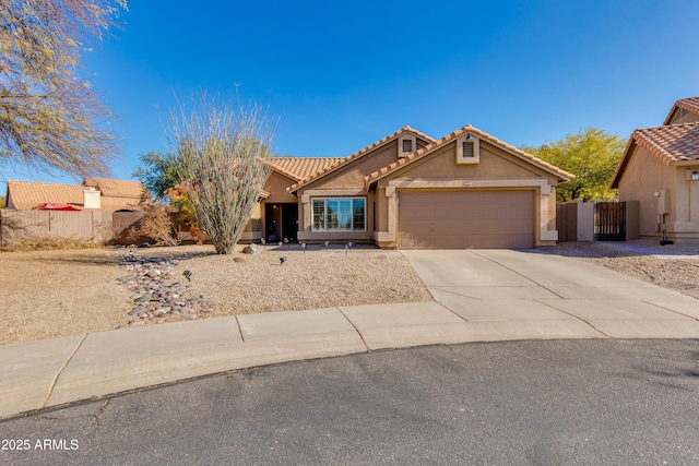 view of front facade featuring driveway, an attached garage, fence, and stucco siding