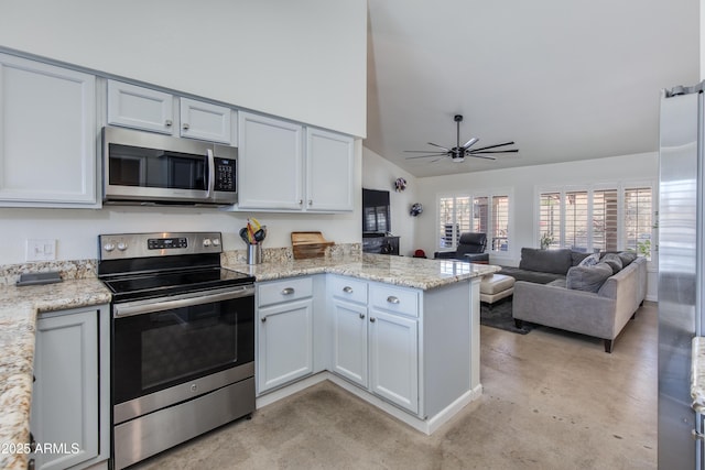 kitchen with light stone counters, appliances with stainless steel finishes, open floor plan, vaulted ceiling, and a peninsula