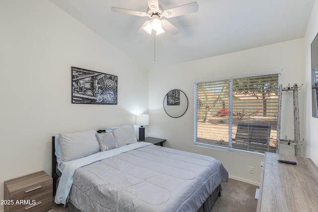 carpeted bedroom with ceiling fan, baseboards, and vaulted ceiling