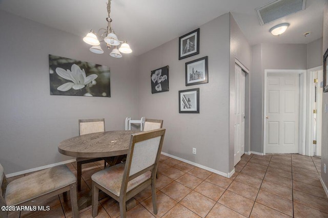 dining space with an inviting chandelier, visible vents, baseboards, and light tile patterned floors