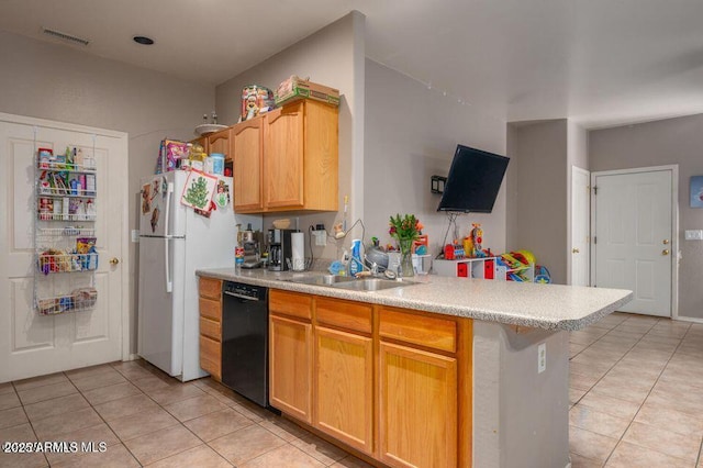 kitchen featuring light tile patterned floors, a peninsula, light countertops, freestanding refrigerator, and dishwasher