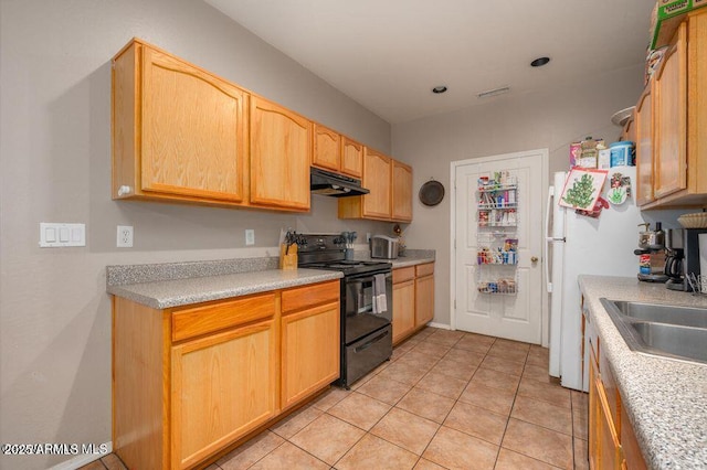 kitchen with light tile patterned floors, light countertops, electric range, freestanding refrigerator, and under cabinet range hood
