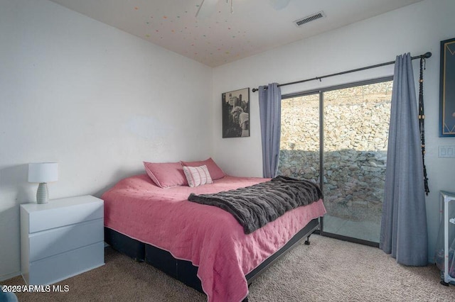 bedroom with carpet floors, access to outside, and visible vents