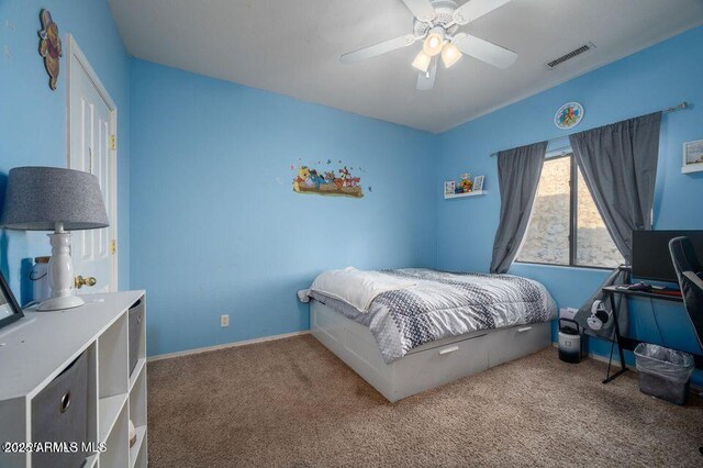 carpeted bedroom featuring baseboards, visible vents, and ceiling fan