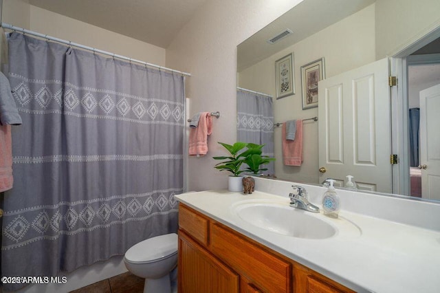 full bathroom with visible vents, a shower with shower curtain, toilet, vanity, and tile patterned floors