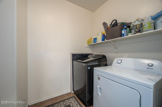 laundry room with washer and dryer, laundry area, tile patterned flooring, and baseboards