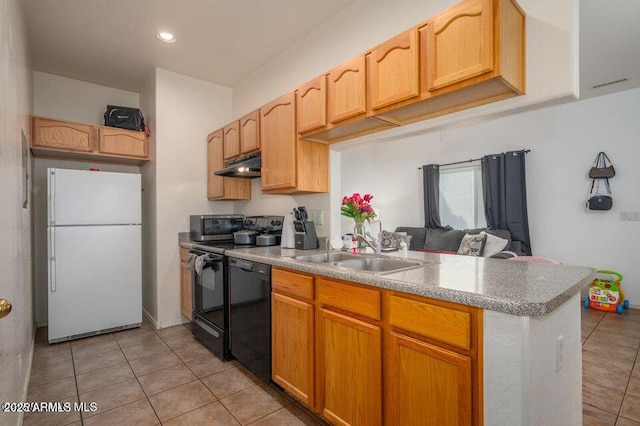 kitchen featuring black dishwasher, freestanding refrigerator, a sink, a peninsula, and under cabinet range hood