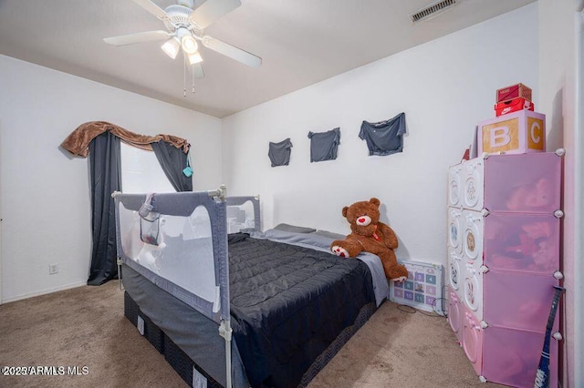 carpeted bedroom with ceiling fan and visible vents